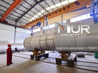 A worker works at a gas purification equipment manufacturing company in Qingzhou Economic Development Zone in Qingzhou, China, on November 9...