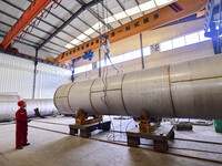 A worker works at a gas purification equipment manufacturing company in Qingzhou Economic Development Zone in Qingzhou, China, on November 9...