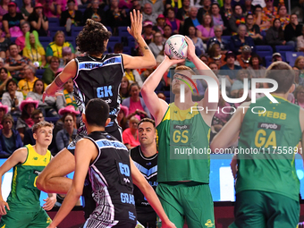 Liam Killey of Australia (second from right) shoots a goal during the Fast5 Netball World Series match between New Zealand and Australia at...