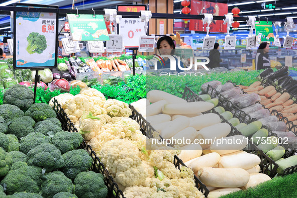 Customers shop for vegetables at a supermarket in Nanjing, China, on November 9, 2024. 