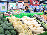 Customers shop for vegetables at a supermarket in Nanjing, China, on November 9, 2024. (