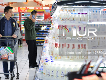 Customers shop for vegetables at a supermarket in Nanjing, China, on November 9, 2024. (