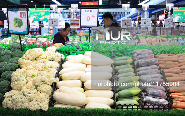 Customers shop for vegetables at a supermarket in Nanjing, China, on November 9, 2024. 