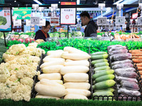 Customers shop for vegetables at a supermarket in Nanjing, China, on November 9, 2024. (