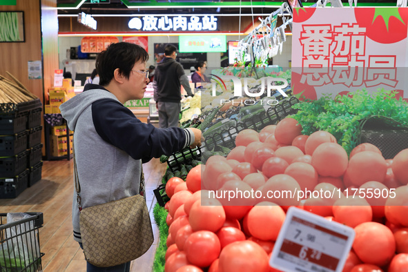 Customers shop for vegetables at a supermarket in Nanjing, China, on November 9, 2024. 