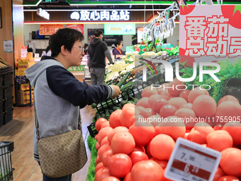 Customers shop for vegetables at a supermarket in Nanjing, China, on November 9, 2024. (