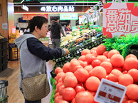 Customers shop for vegetables at a supermarket in Nanjing, China, on November 9, 2024. (