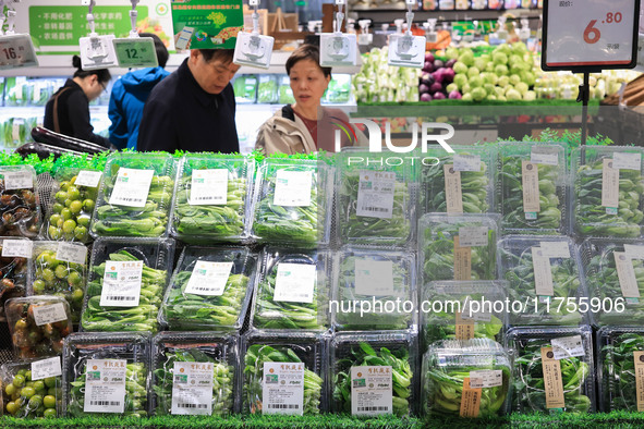 Customers shop for vegetables at a supermarket in Nanjing, China, on November 9, 2024. 