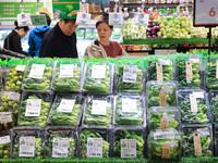 Customers shop for vegetables at a supermarket in Nanjing, China, on November 9, 2024. (