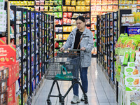 Customers shop for vegetables at a supermarket in Nanjing, China, on November 9, 2024. (