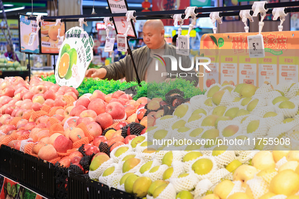 Customers shop for vegetables at a supermarket in Nanjing, China, on November 9, 2024. 