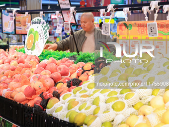 Customers shop for vegetables at a supermarket in Nanjing, China, on November 9, 2024. (