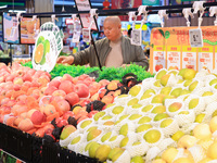 Customers shop for vegetables at a supermarket in Nanjing, China, on November 9, 2024. (