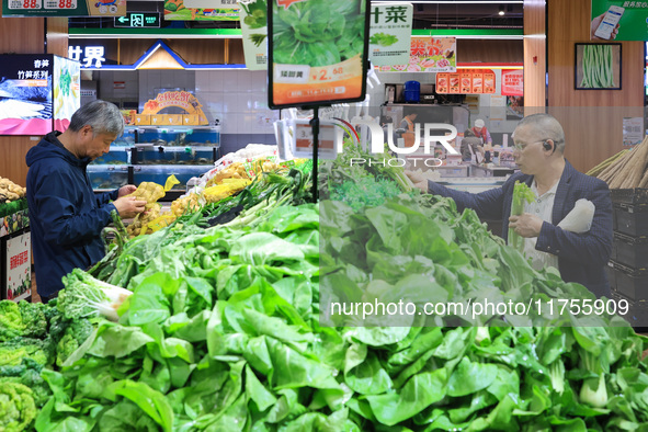 Customers shop for vegetables at a supermarket in Nanjing, China, on November 9, 2024. 