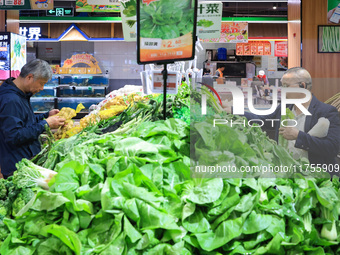 Customers shop for vegetables at a supermarket in Nanjing, China, on November 9, 2024. (