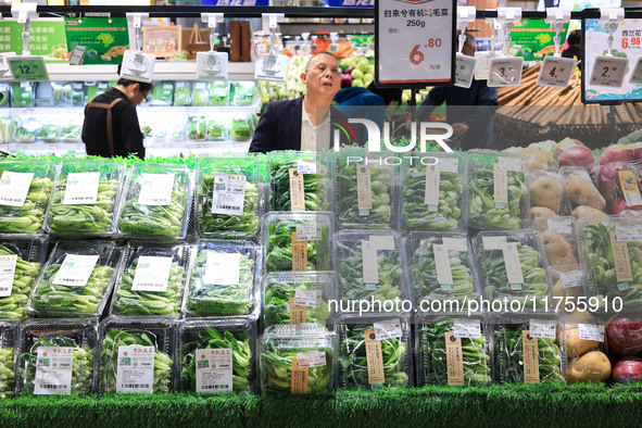 Customers shop for vegetables at a supermarket in Nanjing, China, on November 9, 2024. 