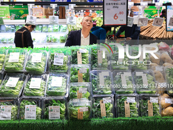 Customers shop for vegetables at a supermarket in Nanjing, China, on November 9, 2024. (