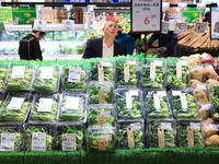 Customers shop for vegetables at a supermarket in Nanjing, China, on November 9, 2024. (