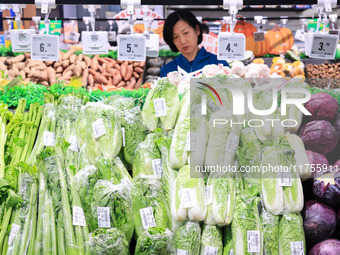 Customers shop for vegetables at a supermarket in Nanjing, China, on November 9, 2024. (