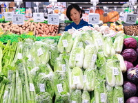 Customers shop for vegetables at a supermarket in Nanjing, China, on November 9, 2024. (