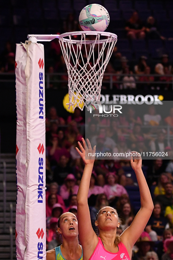 Martina Salmon of New Zealand (R) shoots during the Fast5 Netball World Series match between New Zealand and Australia in Christchurch, New...