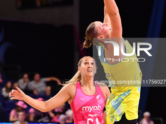 Lucy Austin of Australia and Martina Salmon of New Zealand compete in the Fast5 Netball World Series match between New Zealand and Australia...