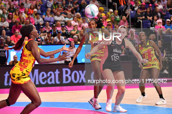 Sandra Nambirige of Uganda (left) and Harriet Jones of England (second from right) participate in the Fast5 Netball World Series match betwe...