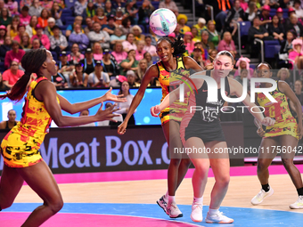 Sandra Nambirige of Uganda (left) and Harriet Jones of England (second from right) participate in the Fast5 Netball World Series match betwe...