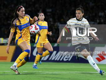 Stephanie Ribeiro #7 of Pumas Femenil and Greta Espinoza #4 of Tigres Femenil fight for the ball during the quarterfinals, first leg, of the...