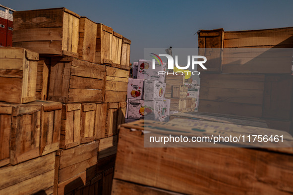 Wooden boxes filled with fresh apples are kept at Asia's second-largest fruit market for sale in Sopore, Jammu and Kashmir, India, on Novemb...