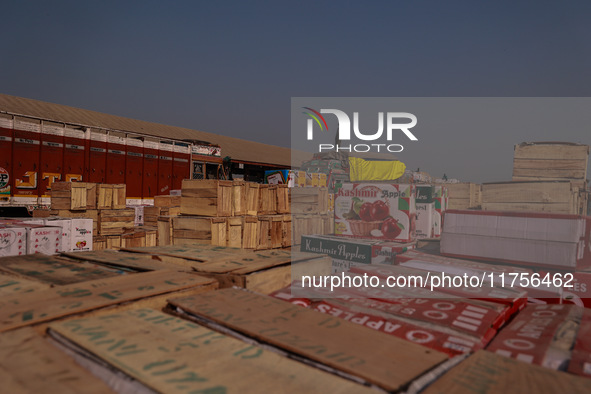 Wooden boxes filled with fresh apples are kept at Asia's second-largest fruit market for sale in Sopore, Jammu and Kashmir, India, on Novemb...