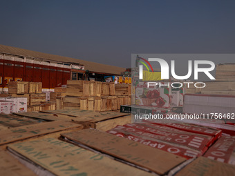 Wooden boxes filled with fresh apples are kept at Asia's second-largest fruit market for sale in Sopore, Jammu and Kashmir, India, on Novemb...