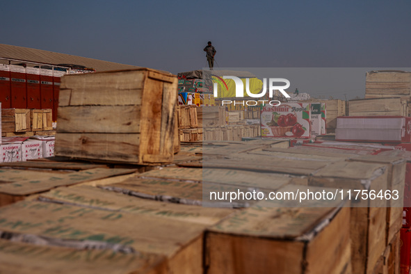 Wooden boxes filled with fresh apples are kept at Asia's second-largest fruit market for sale in Sopore, Jammu and Kashmir, India, on Novemb...