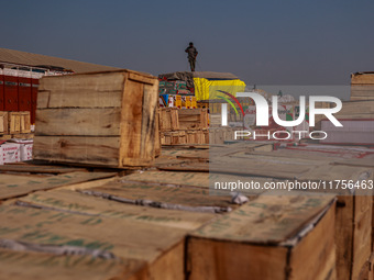 Wooden boxes filled with fresh apples are kept at Asia's second-largest fruit market for sale in Sopore, Jammu and Kashmir, India, on Novemb...