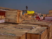 Wooden boxes filled with fresh apples are kept at Asia's second-largest fruit market for sale in Sopore, Jammu and Kashmir, India, on Novemb...