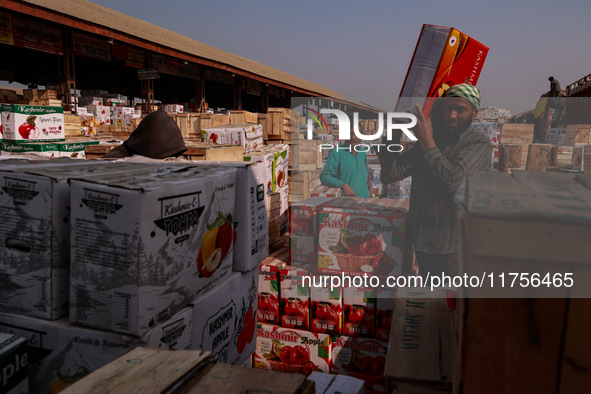 Labourers load apple boxes onto trucks, which are sent to different parts of the country from Asia's second-largest fruit mandi in Sopore, J...