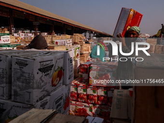 Labourers load apple boxes onto trucks, which are sent to different parts of the country from Asia's second-largest fruit mandi in Sopore, J...