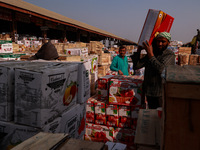 Labourers load apple boxes onto trucks, which are sent to different parts of the country from Asia's second-largest fruit mandi in Sopore, J...