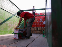 Labourers load apple boxes onto trucks, which are sent to different parts of the country from Asia's second-largest fruit mandi in Sopore, J...