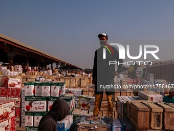 Labourers load apple boxes onto trucks, which are sent to different parts of the country from Asia's second-largest fruit mandi in Sopore, J...