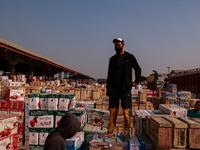 Labourers load apple boxes onto trucks, which are sent to different parts of the country from Asia's second-largest fruit mandi in Sopore, J...