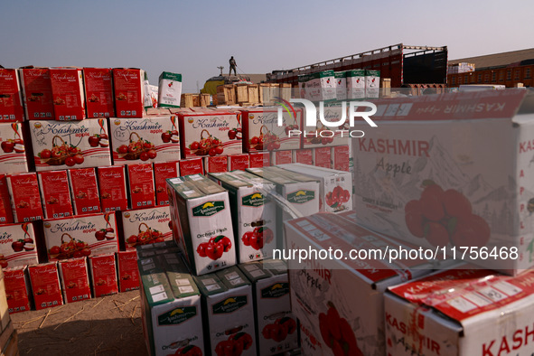 Labourers load apple boxes onto trucks, which are sent to different parts of the country from Asia's second-largest fruit mandi in Sopore, J...