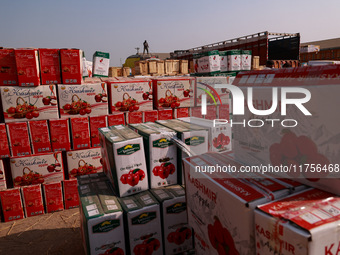 Labourers load apple boxes onto trucks, which are sent to different parts of the country from Asia's second-largest fruit mandi in Sopore, J...