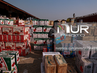 Labourers load apple boxes onto trucks, which are sent to different parts of the country from Asia's second-largest fruit mandi in Sopore, J...