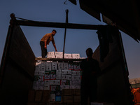 Labourers load apple boxes onto trucks, which are sent to different parts of the country from Asia's second-largest fruit mandi in Sopore, J...