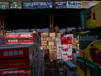 Labourers load apple boxes onto trucks, which are sent to different parts of the country from Asia's second-largest fruit mandi in Sopore, J...