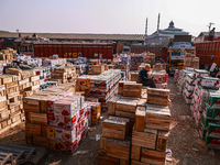 Labourers load apple boxes onto trucks, which are sent to different parts of the country from Asia's second-largest fruit mandi in Sopore, J...