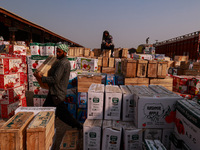 Labourers load apple boxes onto trucks, which are sent to different parts of the country from Asia's second-largest fruit mandi in Sopore, J...