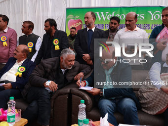 Deputy Chief Minister Surinder Kumar Choudhary talks with MLA Sopore Irshad Rasool Kar during a program at Asia's 2nd Largest Fruit Mandi in...