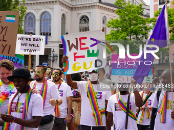 A group of Black refugees marches during Christopher Street Day (CSD) in Munich, Germany, on June 22, 2024, holding colorful signs advocatin...